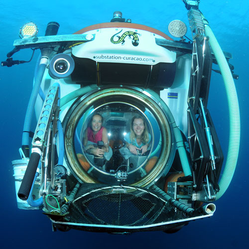 two women inside a submersible porthole window