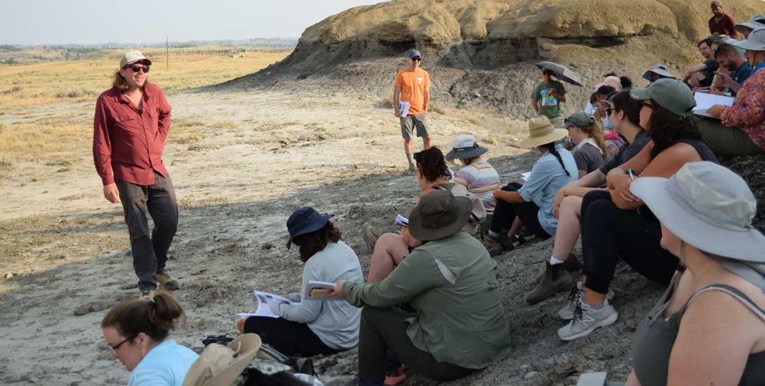 DIG Instructors Dr. Dave Grossnickle and PhD student Brody Hovatter show participants the K-Pg boundary.  