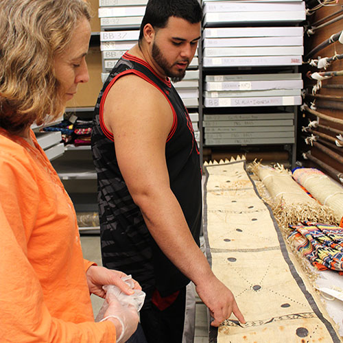 a student and professor look at art together