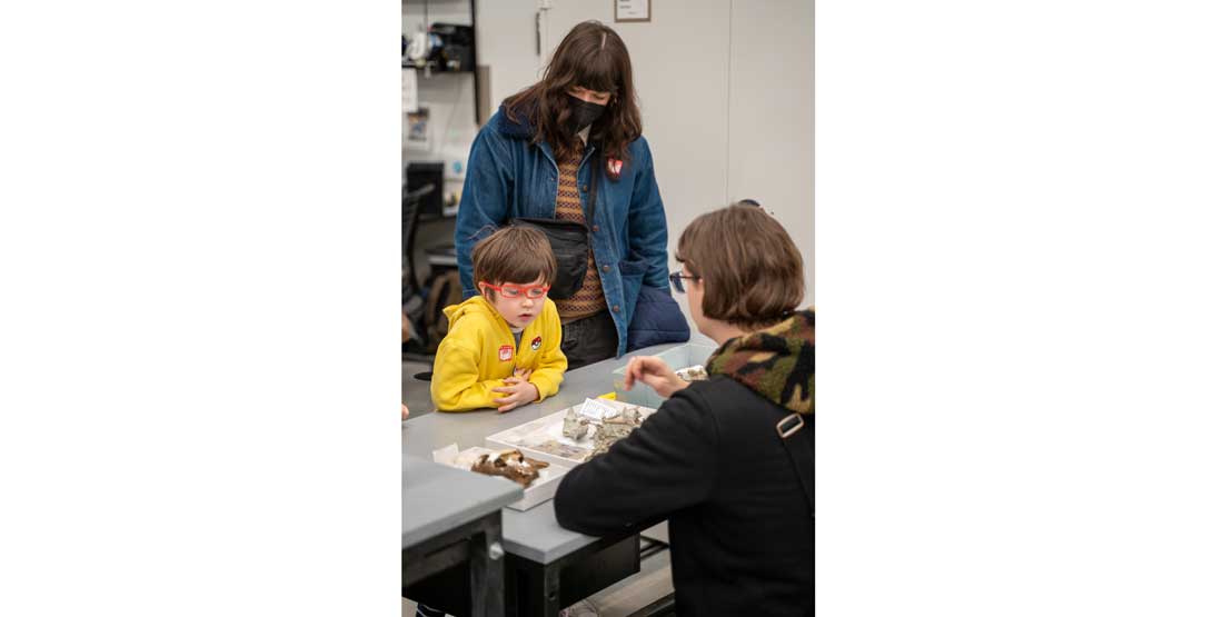 a child and an adult at members behind-the-scenes