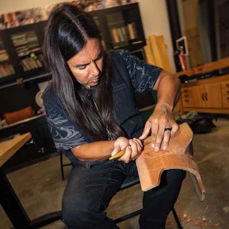 James Johnson (Tlingit) works on a carving
