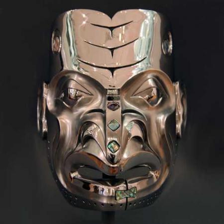 a mask cast in stainless steel with abalone
