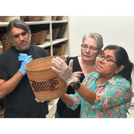 artists in the arts & cultures collections look at a basket